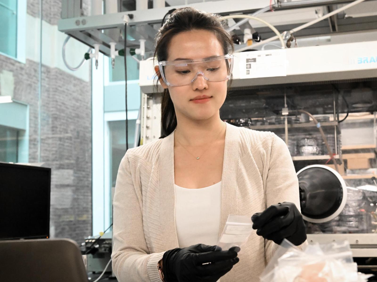 Yi-Chen Lan, doctoral student in chemical engineering at Penn State and first author of a paper published in ChemSusChem, holds a battery coin cell that contains composite electrolytes reprocessed through cold sintering.